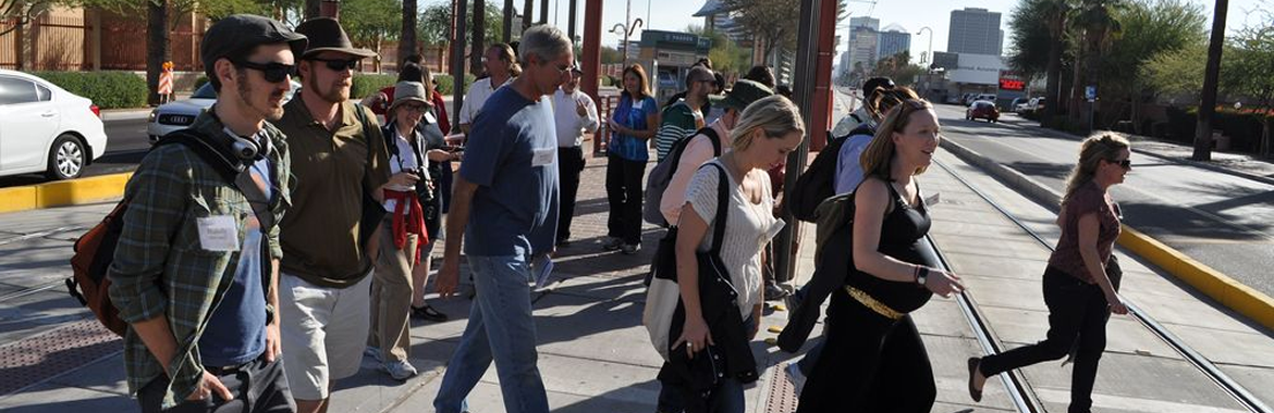 adults in a group walking to cross the street