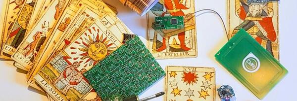 small green circuit board on top of tarot cards
